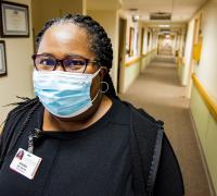 Portrait of Sandra Belton, RN, MSN standing in the hallways of UVM Medical Center. 