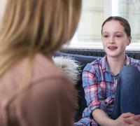 Teenage girl talking with mother. 