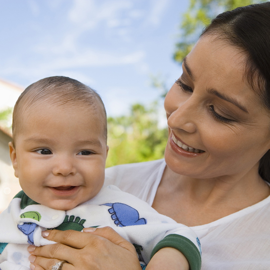 A woman holding a smiling baby