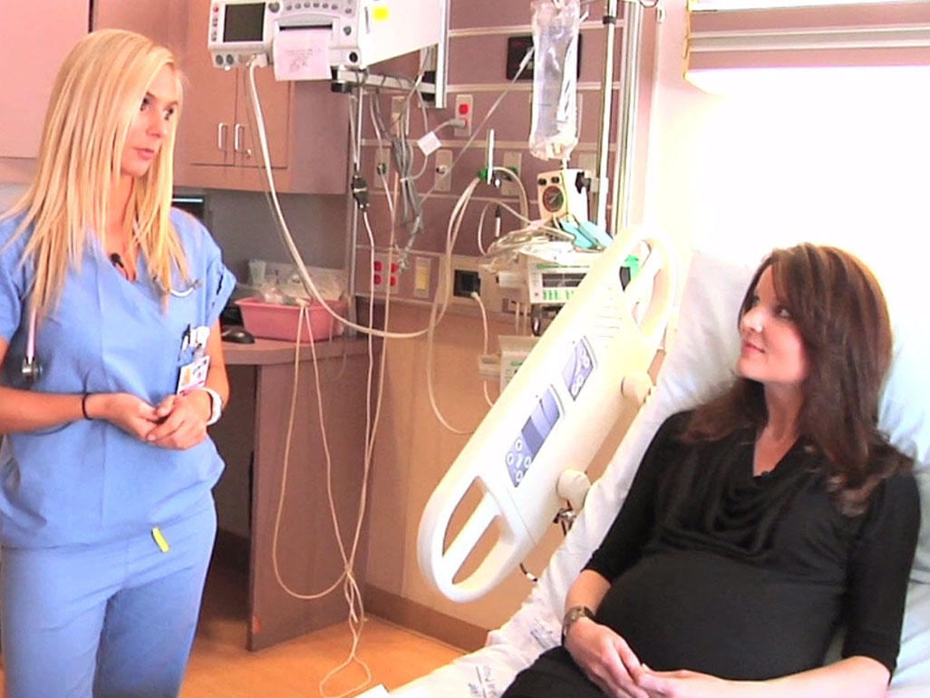 woman in hospital bed talking to nurse