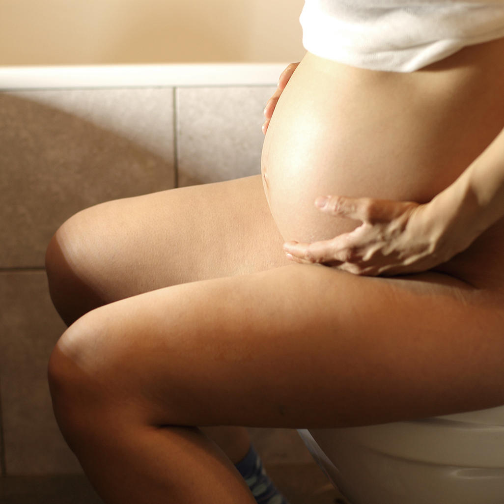 pregnant woman on the toilet