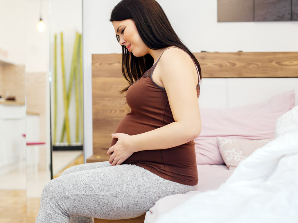 pregnant woman holding her belly