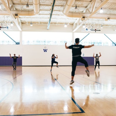 A group of fitness instructors dances in one of the IMA gyms.