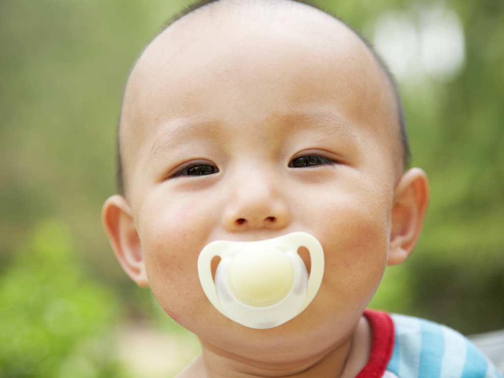 child with pacifier in his mouth