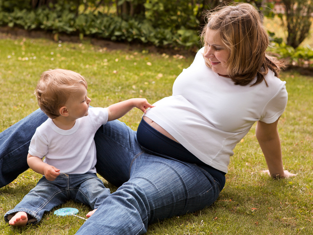 boy playing with mother's belly