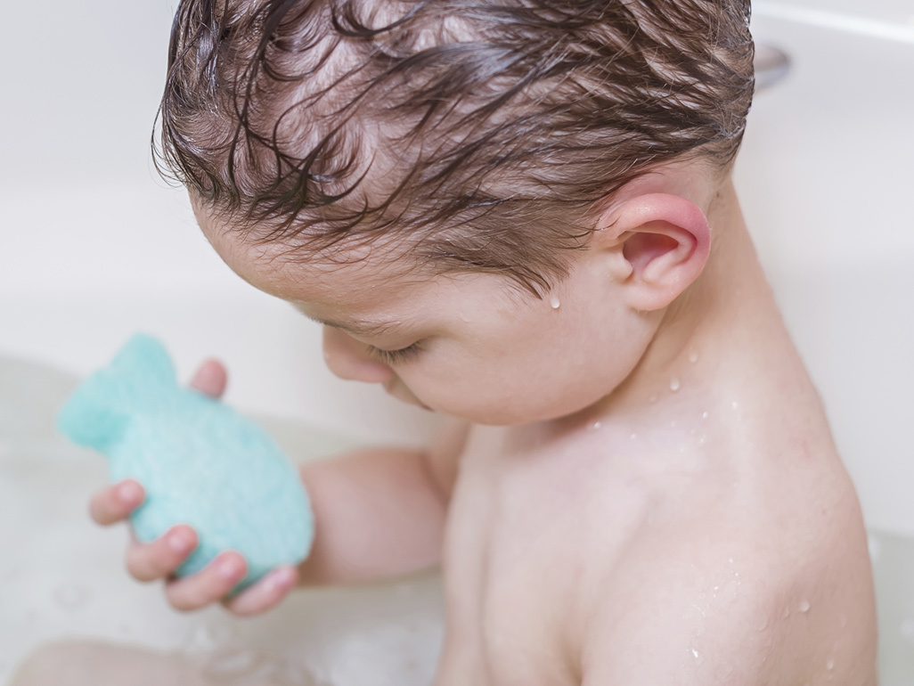 child taking a bath