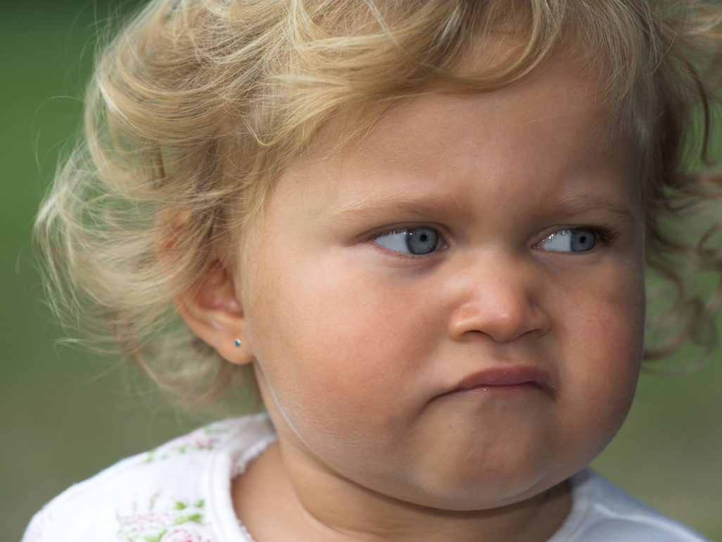 little blonde girl looking mad