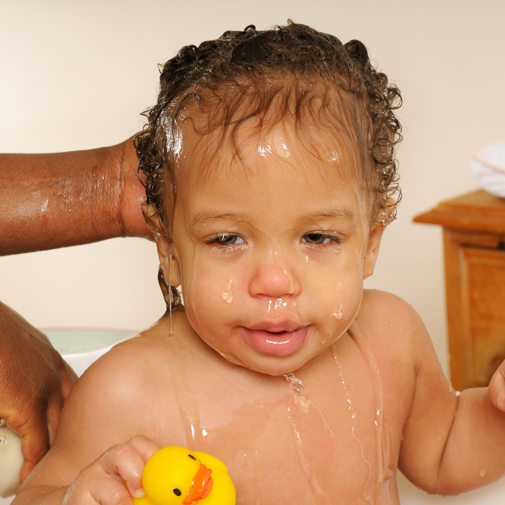 Mom giving baby a bath