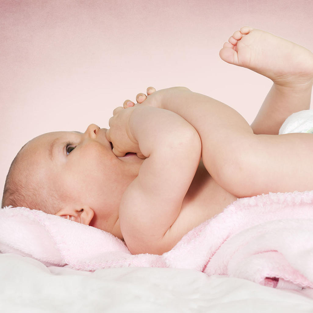 baby putting her foot in her mouth