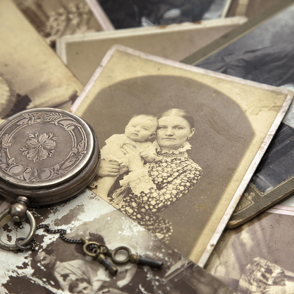 vintage pocket watch standing on rustic mum holding her baby photo