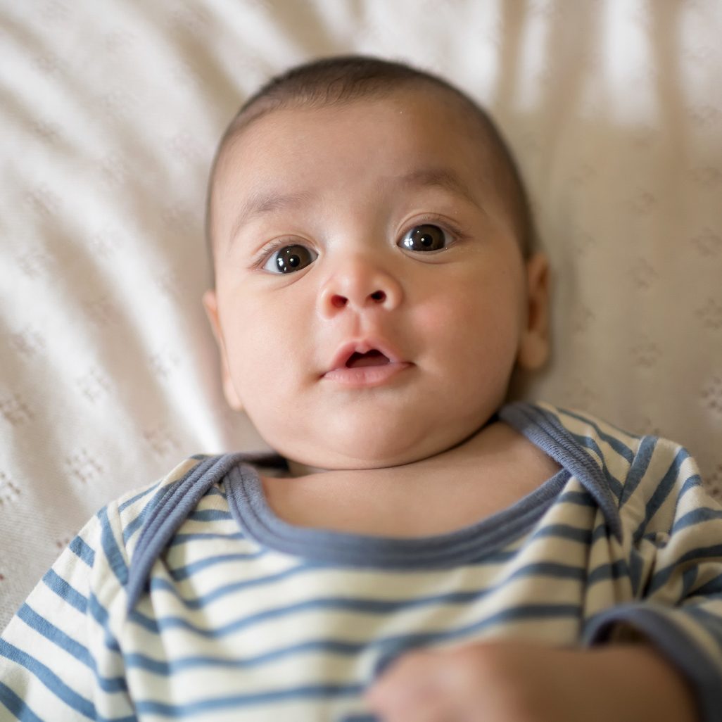 baby wearing blue and white stripe onesie