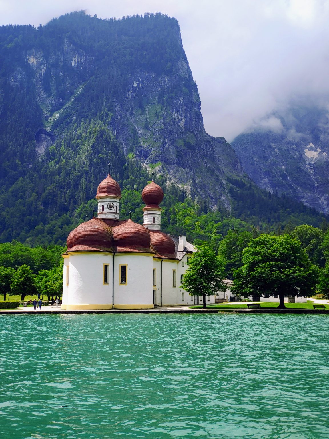 Lake Königssee and church of Sankt Bartholomae (St. Bartholomew) with mountain scenery behind. Bayern (Bavaria), Germany. Photo contributed by Anariel Design to the WordPress Photo Directory.