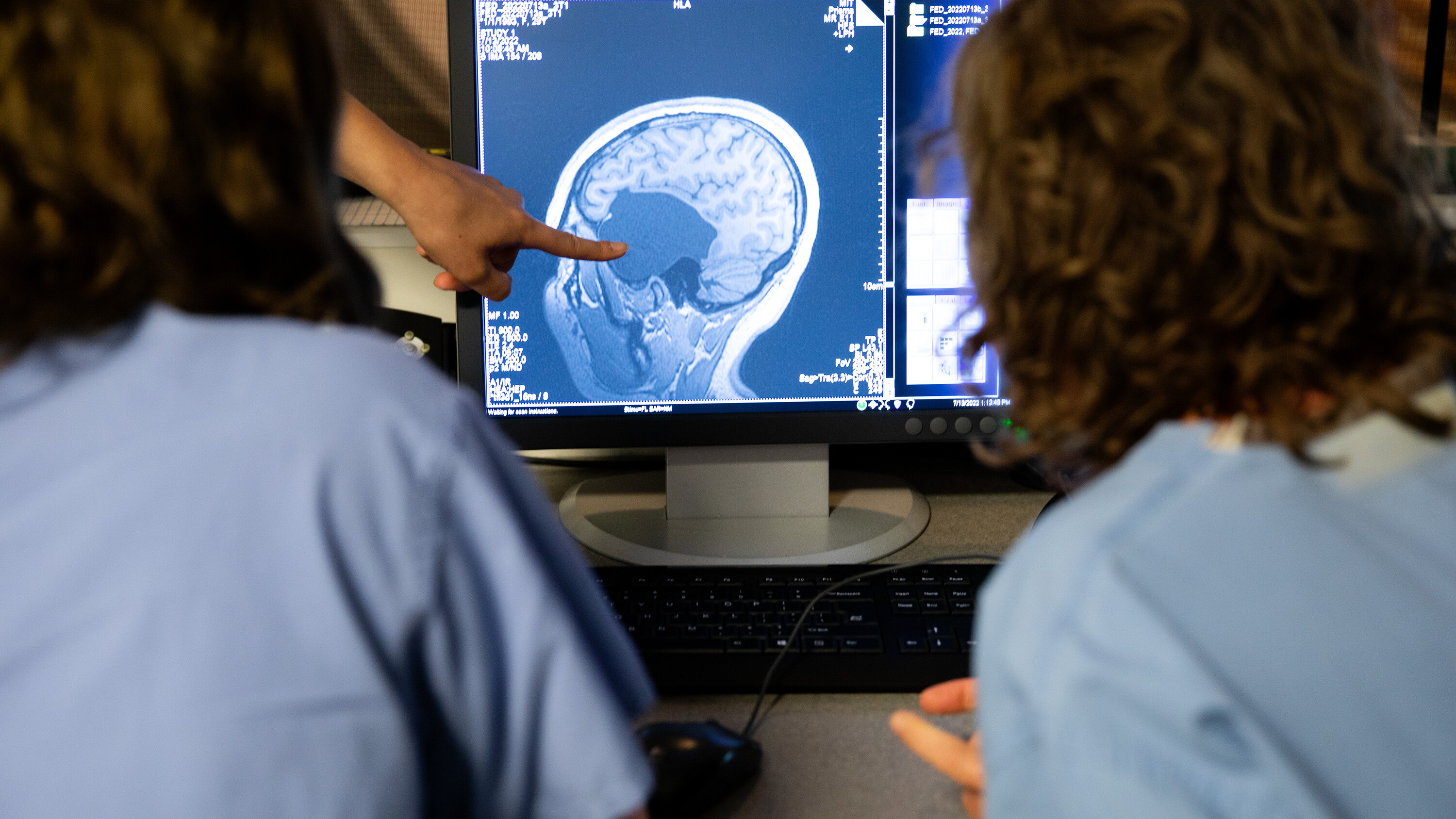 Helen Santoro, left, examining a scan of her brain with her mother at an M.I.T. lab in Cambridge, Mass., in July.