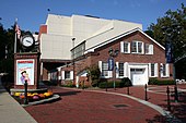 Entrance to the theater Paper Mill Playhouse with the poster to a play outside it