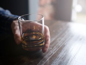 Man holding glass of whisky 