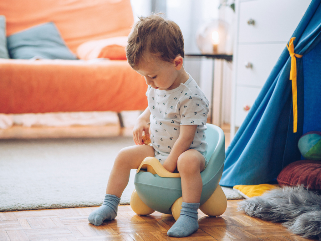 toddler boy sitting on potty