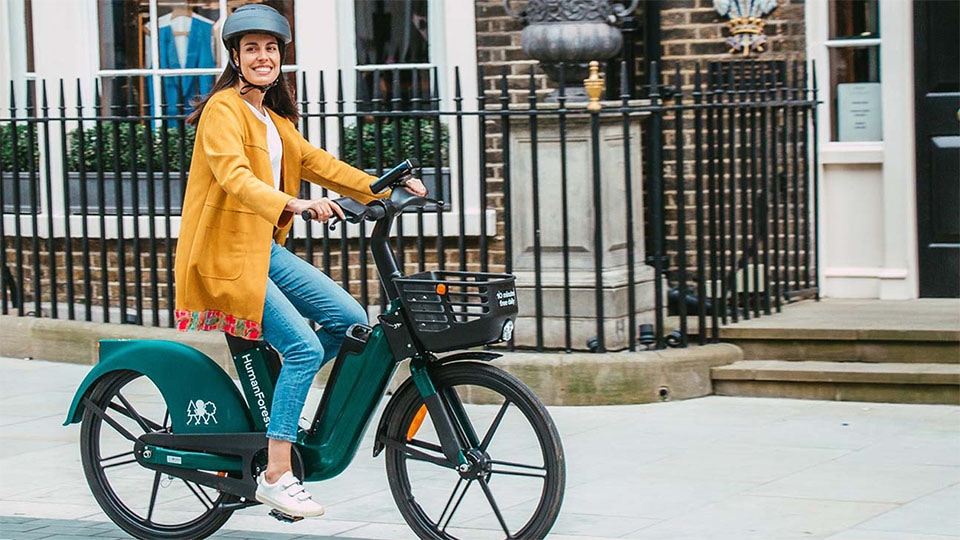 Woman riding Human Forest bike in London. 