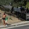 A student is picked up and comforted by a loved one outside Oakland Academy of Knowledge near Sojourner Truth School, where an afternoon mass shooting occurred on Wednesday, September 28, 2022 in Oakland, Calif. Six shooting victims have been transported to area hospitals.