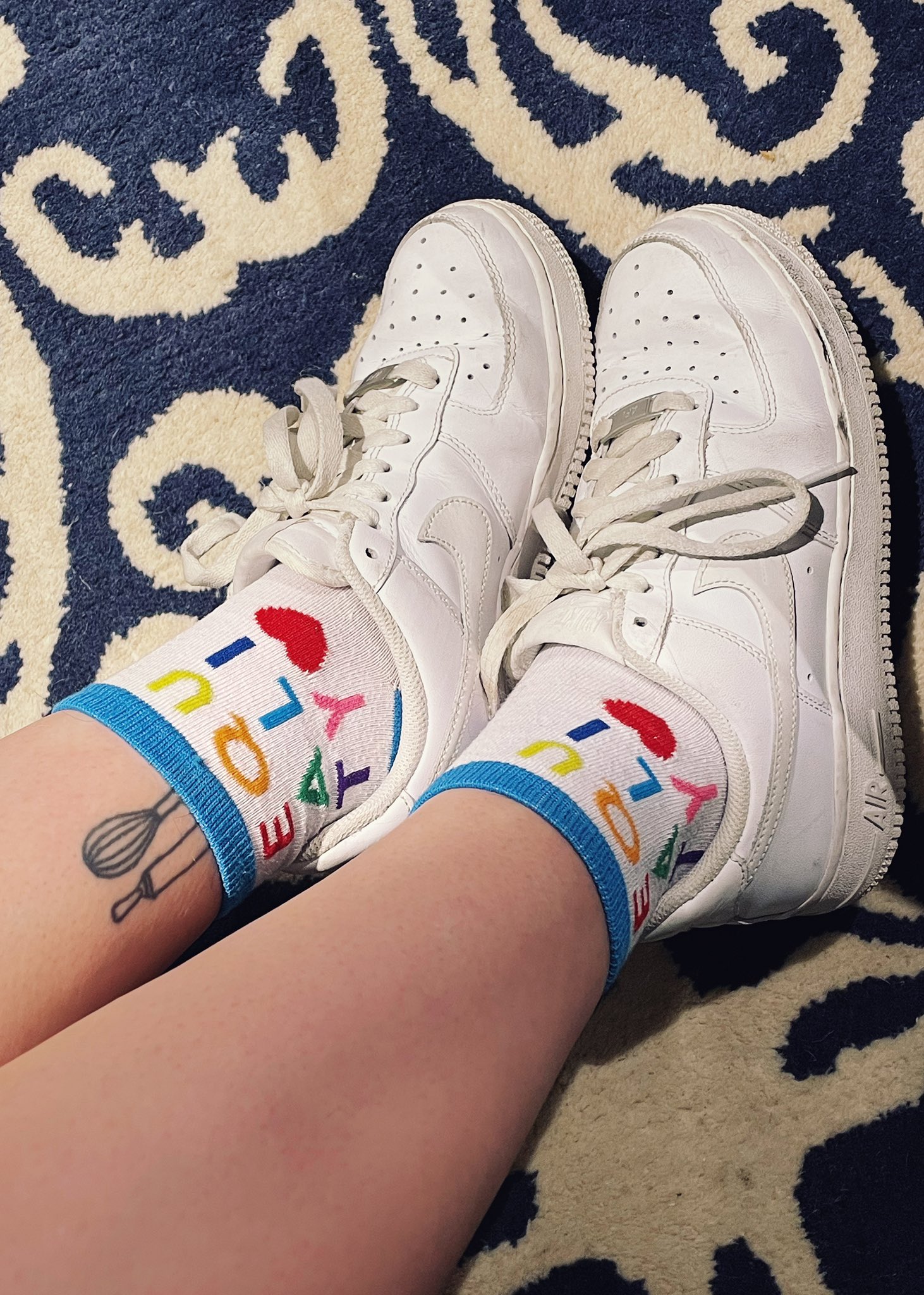 White Air Force one sneakers. Equality socks.