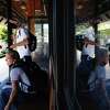 Chronicle columnist Heather Knight, culture critic Peter Hartlaub and route co-creator Hayden Miller (left) return to the Orinda BART Station after skipping a delayed County Connection bus in Orinda.