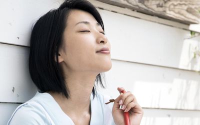 A woman having a break taking deep breaths to reduce stress