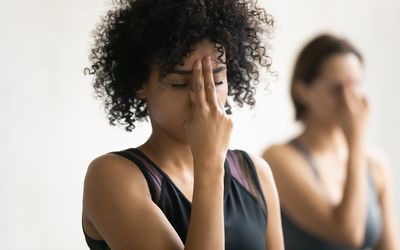 Woman doing alternate nostril breathing exercise