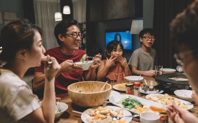 asian family enjoying a meal together