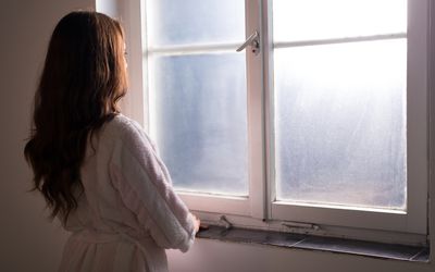 Woman looking out window.