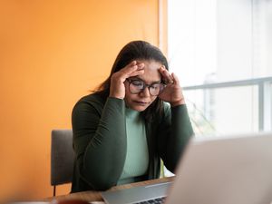 person stressed at their desk