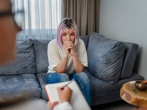 Hopeless Young woman talking with her Therapist