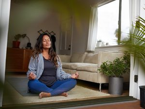 person meditating in living room