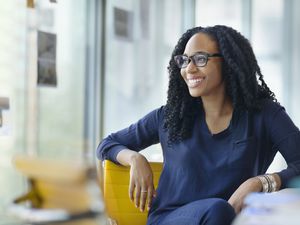 Woman looking sideways to window in design office