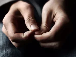 Close up of woman's hands as she's picking her nails