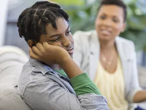 Mother talking to a moody teenager