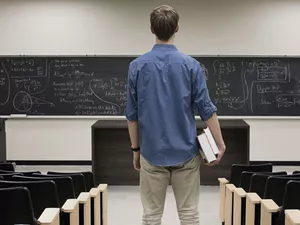 Standing in empty classroom