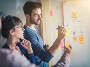 Young creative business people brainstorming on white board