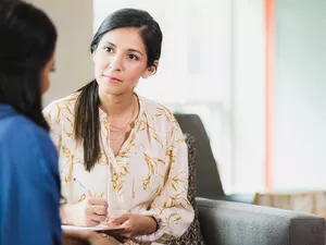 Caring counselor listening to female patient