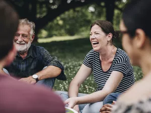 Cheerful woman in the park with her friends