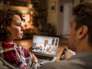 Young couple talking with their doctor on a video call 