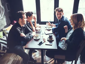 Couple friends having coffee together.