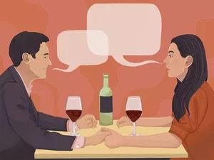 a couple talking over wine at a restaurant