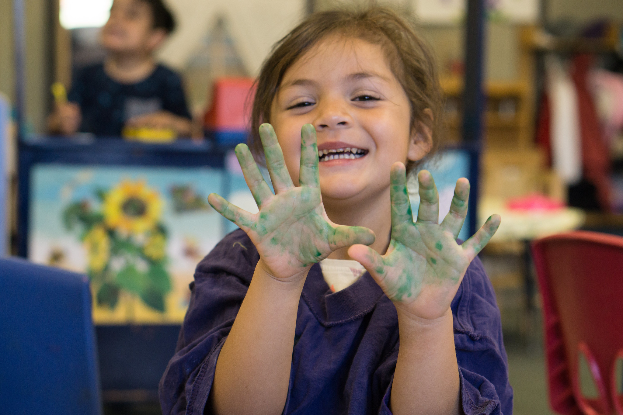 Little girl with paint on hands