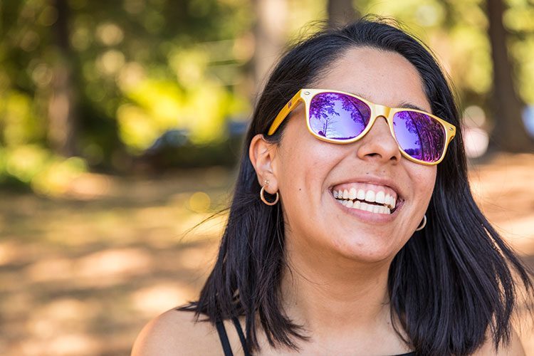 UW student with purple and gold sun glasses