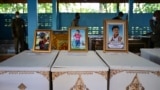 Portraits of young victims of a mass shooting in a nursery are displayed atop their coffins as funeral preparations get underway at Wat Si Uthai temple in Thailand's northeastern Nong Bua Lam Phu province.