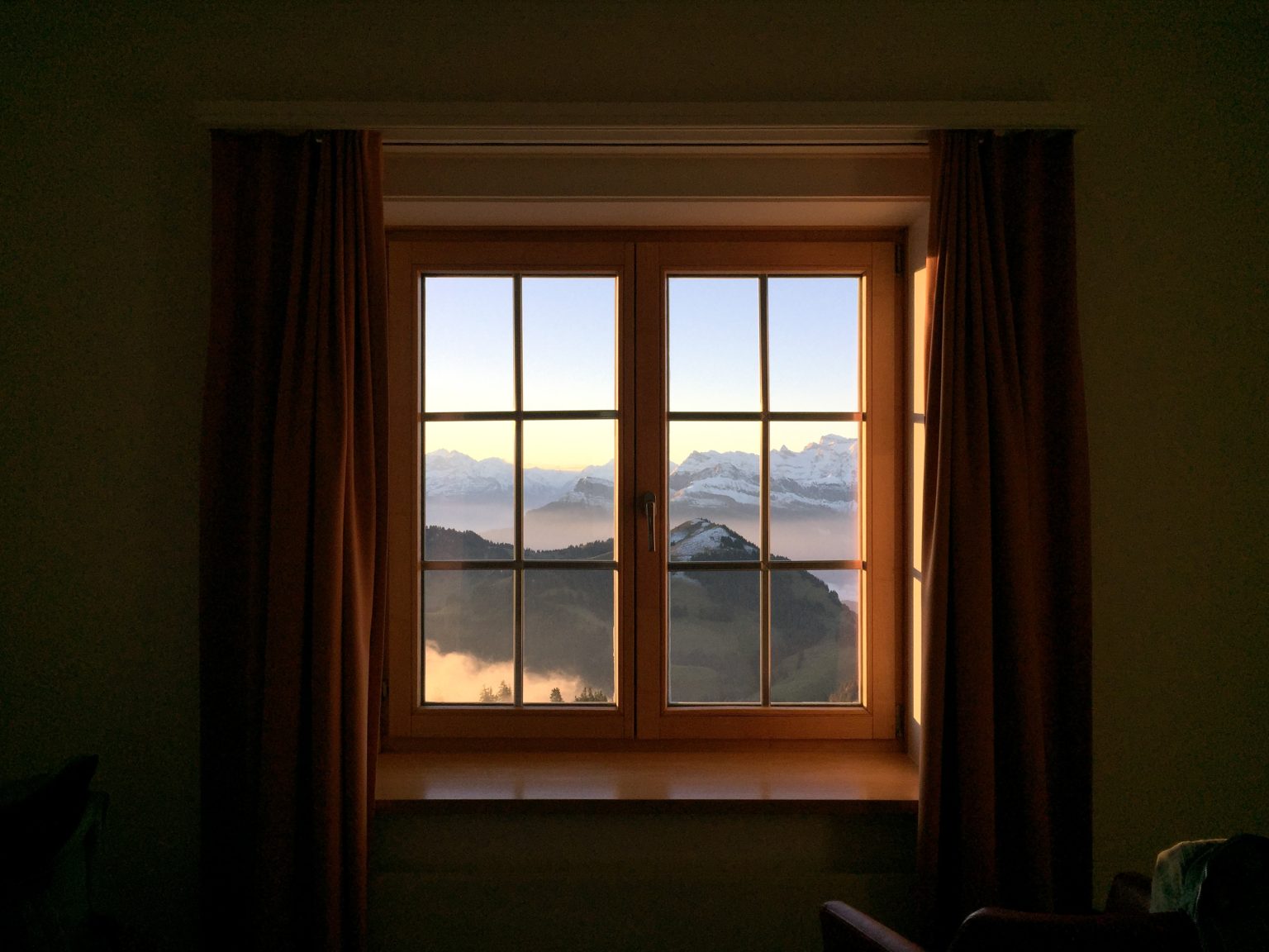 View on the Swiss Alps through a window.