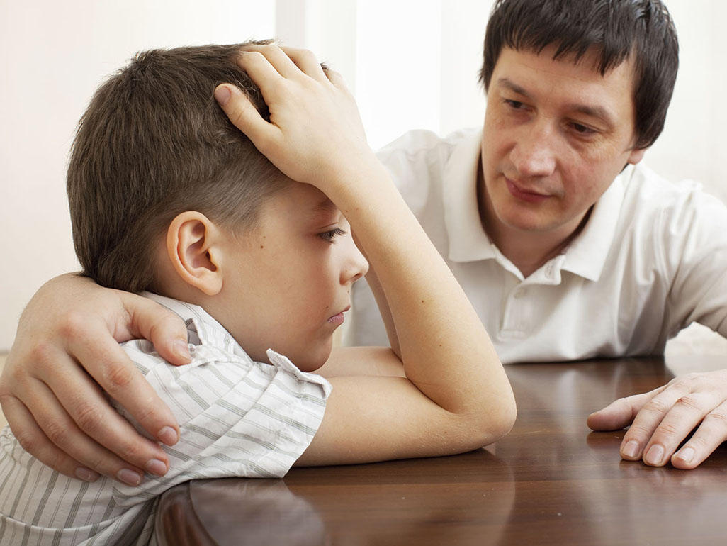 Man sitting and talking with a boy