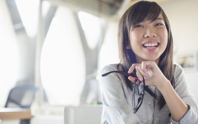 Woman sitting at desk and smiling