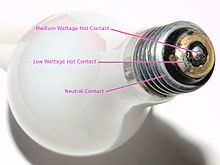 Screw base bulb showing center contact, metal screw thread shell contact, and the extra ring contact around the center contact