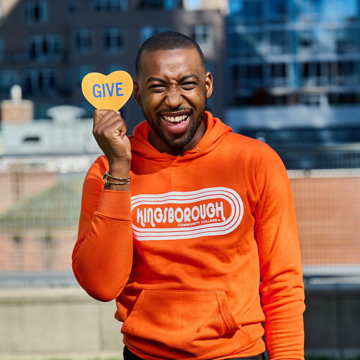 Student holding a CUNY Tuesday heart