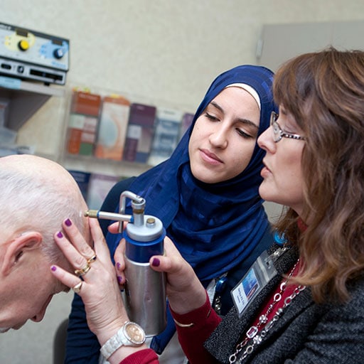 Mayo Clinic M.D. Program student observing faculty member completing a dermatology procedure